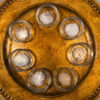 Seven finishing salts in small glass bowls arranged on a gold tray for a side-by-side tasting.