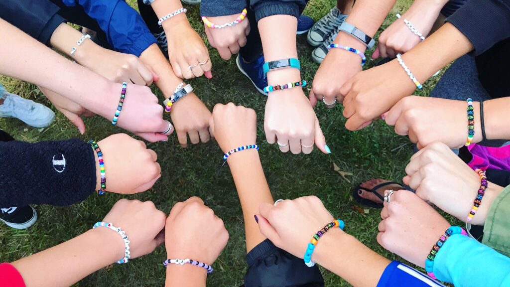 Summer camp jewelry trend of 2021, including friendship bracelets, beaded necklaces and earrings.