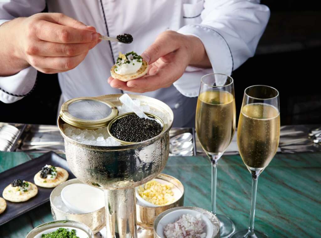 Essentials for the casual caviar trend at luxury holiday party, including brands, potato chips, serving dishes and best champagne pairings.