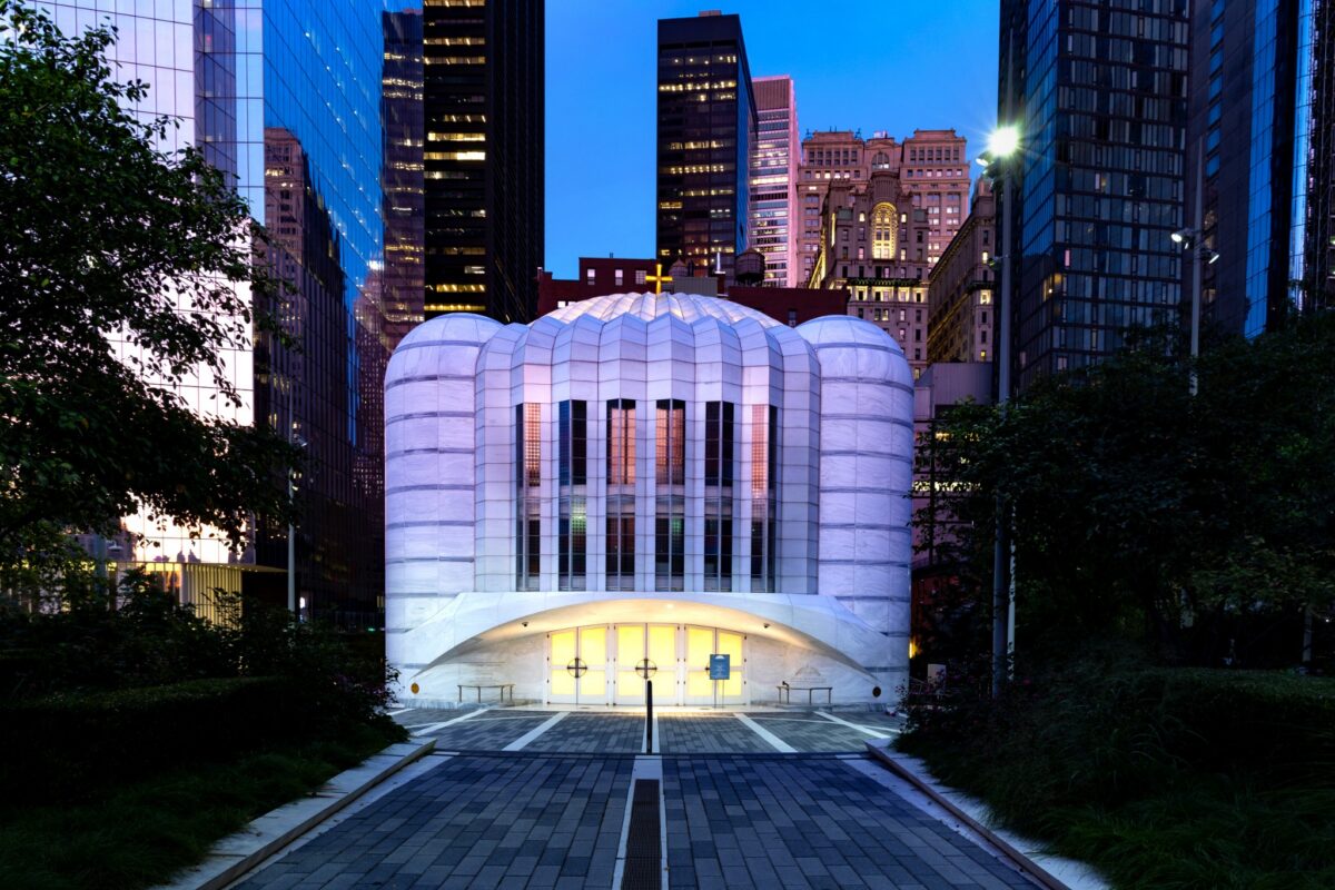Saint Nicholas Greek Orthodox Church and National Shrine glowing at twilight in Lower Manhattan.