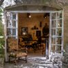 Antique shop doorway in Provence with layered French furniture and decorative objects, lead image for luxury gifts from France.