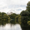 London park lake with the London Eye beyond trees, featured image for a post on luxury gifts from the UK.