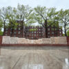 Richmond Barthé’s restored Exodus and Dance frieze at Kingsborough Houses in Brooklyn, seen across wet concrete after rain.