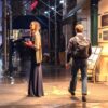 Woman waiting outside a Broadway theater on a rainy night in New York City, lead image for a Dandelion Chandelier essay on celebrity casting on Broadway.