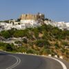 Patmos Chora with the Monastery of Saint John above whitewashed houses in Greece, featured in a guide to European beach towns with culture.