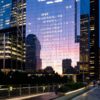 Twilight reflection in a glass New York tower for Dandelion Chandelier’s June 2026 luxury events calendar.