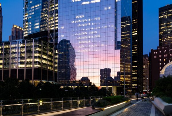 Twilight reflection in a glass New York tower for Dandelion Chandelier’s June 2026 luxury events calendar.