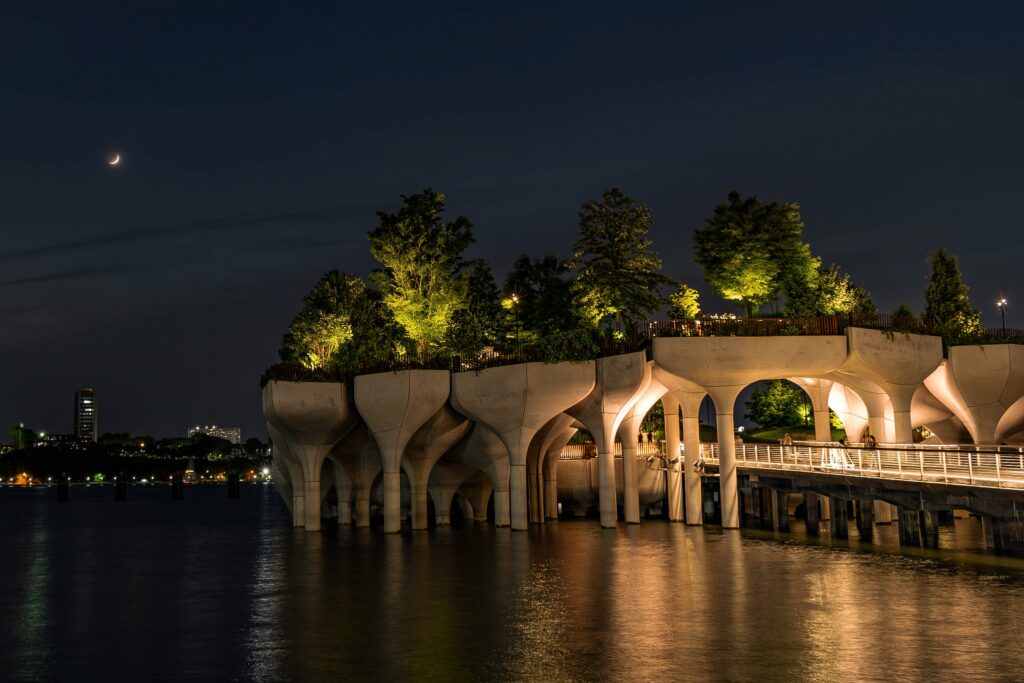 Little Island at night on the Hudson River in New York, lit for summer performances.