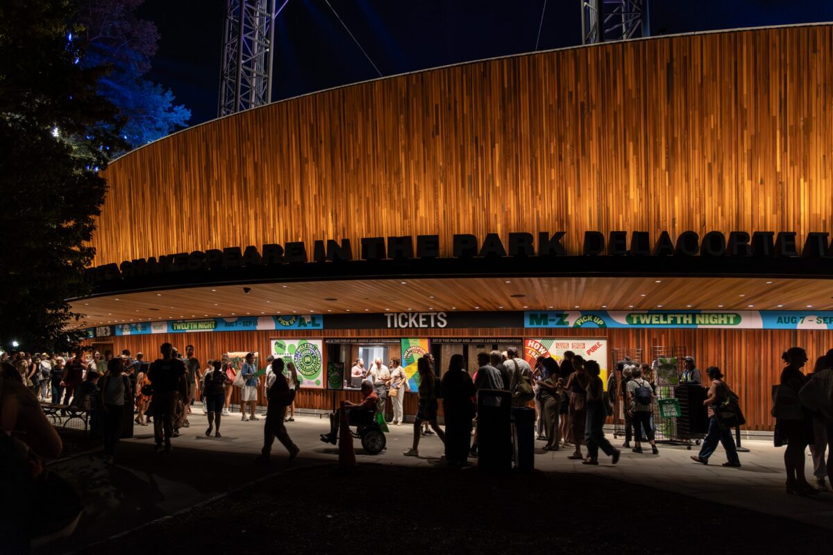 Crowd outside the Delacorte Theater at night during Shakespeare in the Park in Central Park, New York.