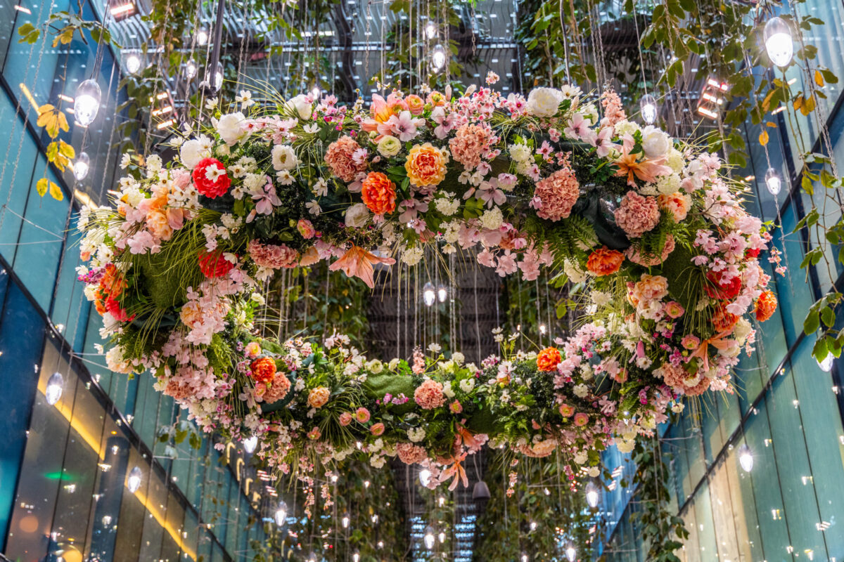 Large suspended floral heart beneath hanging lights, photographed by Pamela Thomas-Graham for a guide to the best luxury romantic gifts.