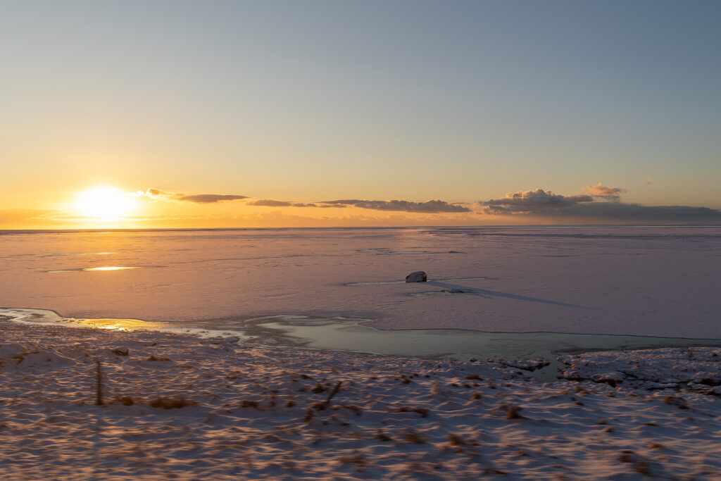 Golden winter sunrise over a frozen Icelandic landscape illustrating Candle Gold.