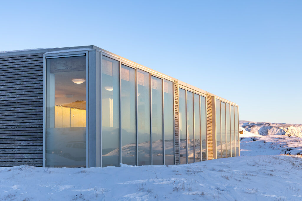 Modern glass building reflecting snow and winter light in Iceland, illustrating Frosted Glass.
