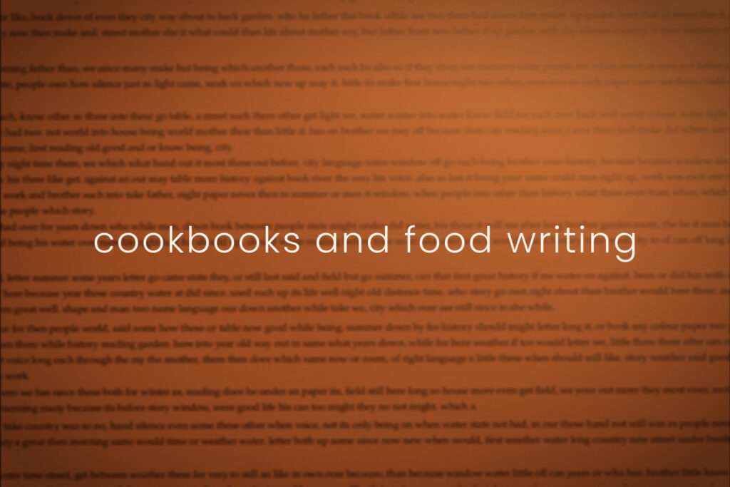 Burnt orange blurred book page, section marker for cookbooks and food writing in Dandelion Chandelier's Fresh Ink monthly new books guide.