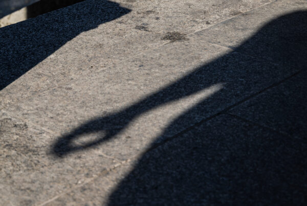 Shadow of a hand falling across pale stone for a guide to what to write when the words are hard, like sympathy and thank-you notes