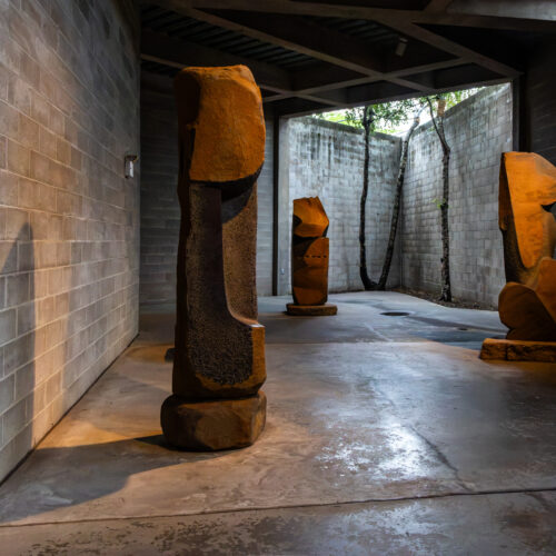 Stone sculptures in a shadowed courtyard at The Noguchi Museum in Queens, New York; photograph by Pamela Thomas-Graham.