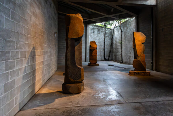 Stone sculptures in a shadowed courtyard at The Noguchi Museum in Queens, New York; photograph by Pamela Thomas-Graham.