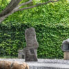 Noguchi Museum sculpture garden with stone works beneath a mature tree in Queens, photographed by Pamela Thomas-Graham.